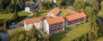 Luftbild der Suchtklinik Allgäu - grüne Wiesen, Bäume und Alpenpanorama